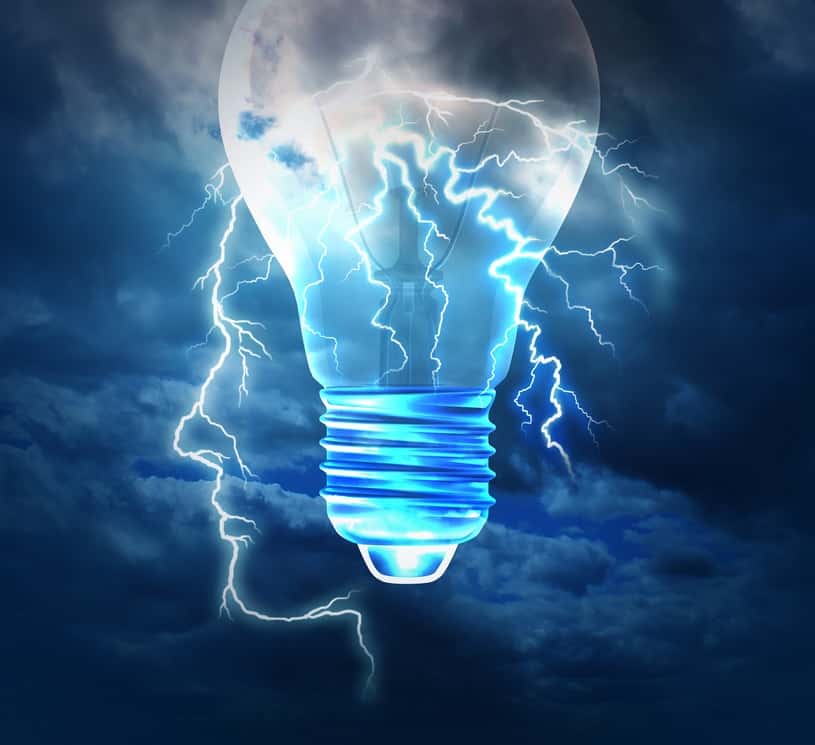 Lightbulb superimposed ona the outline of a face over a stormy sky signifying making a decision with a decision coach.