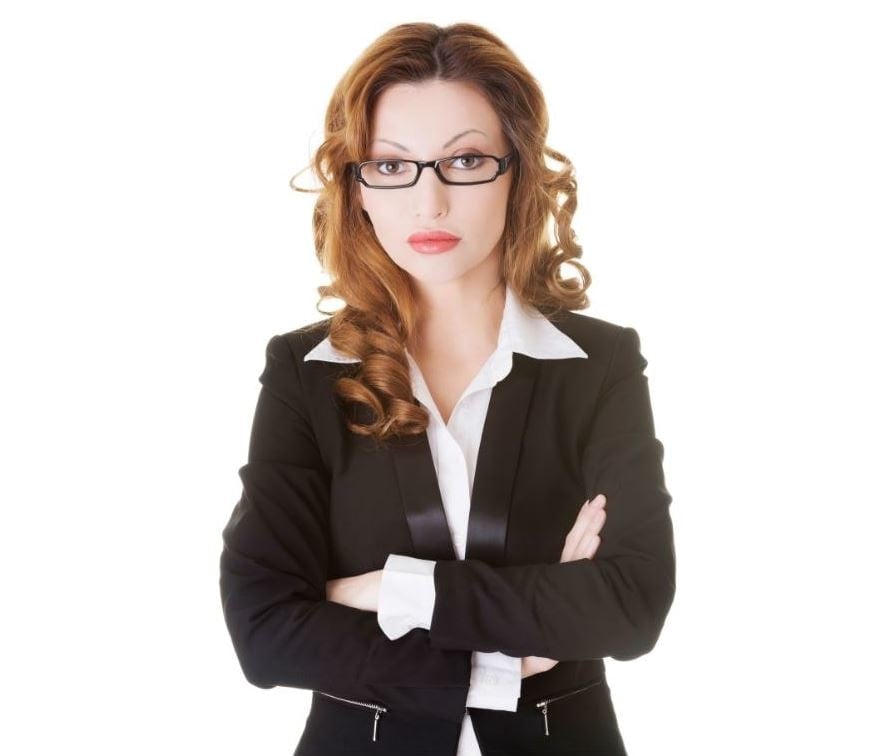 Beautiful woman with red hair in a business suit and glasses.