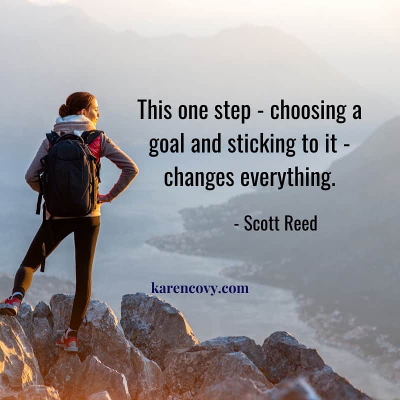 Woman hiker standing on a mountain top with the quote: This one step- choosing a goal and sticking to it - changes everything. How to Set Goals for Your Divorce.