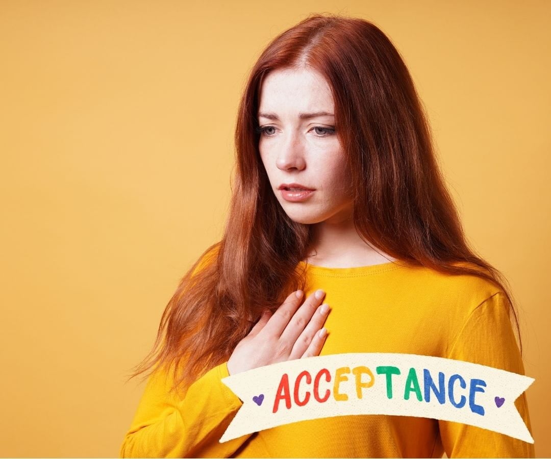 woman with a hand on her chest signifyng acceptance