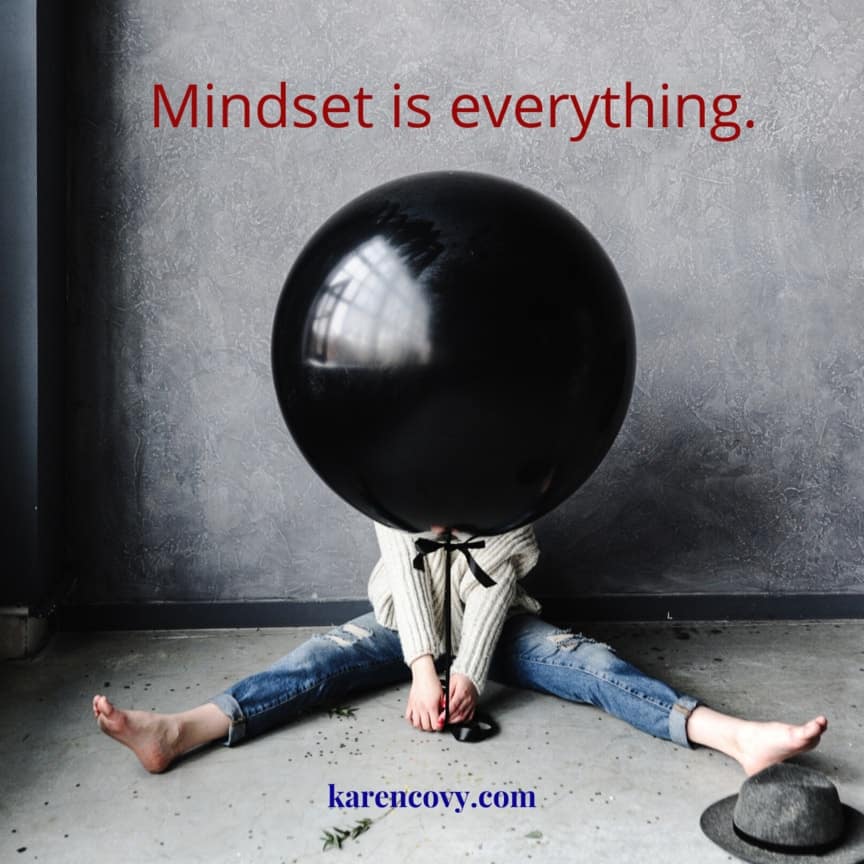 Woman with giant black balloon in front of her head with saying: Mindset Matters. Mindset is everything.