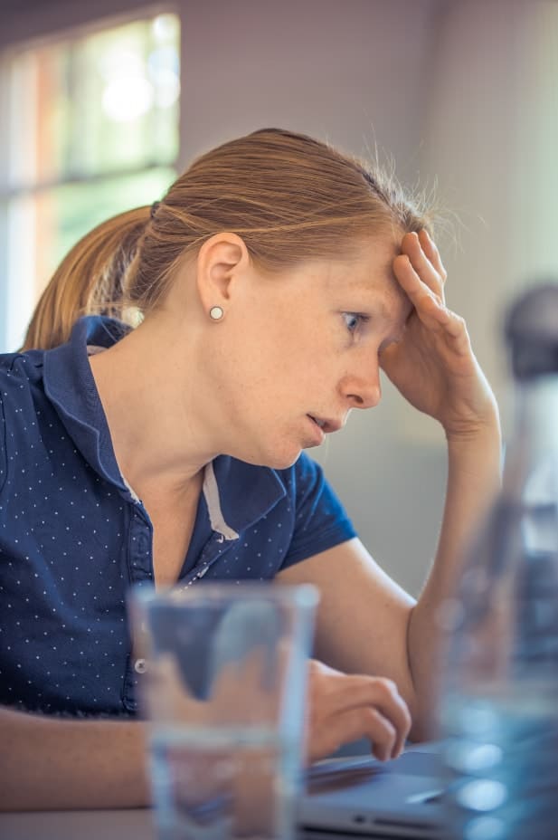 Woman staring at a computer experiencing decision fatigue in her divorce.