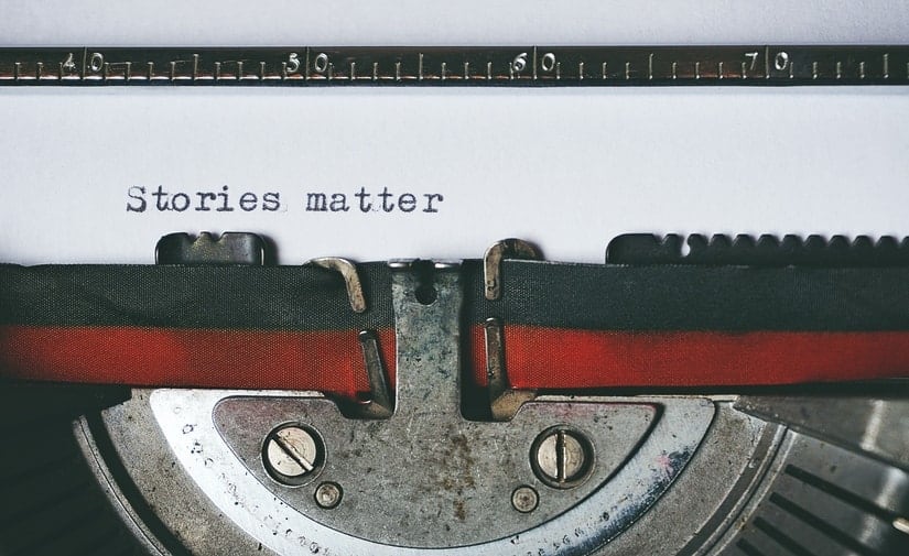 Old typewriter with black and red ribbon typed "Stories matter." Your divorce story matters.