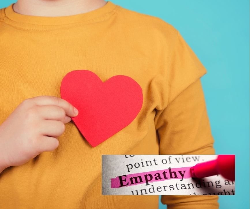 a man holding a paper cutout of a heart over his chest, symbolizing empathy