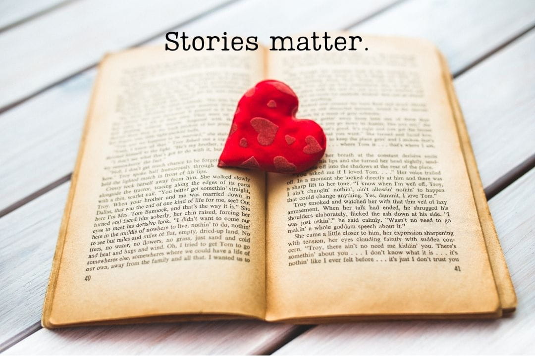 open book and a heart. Stories matter.