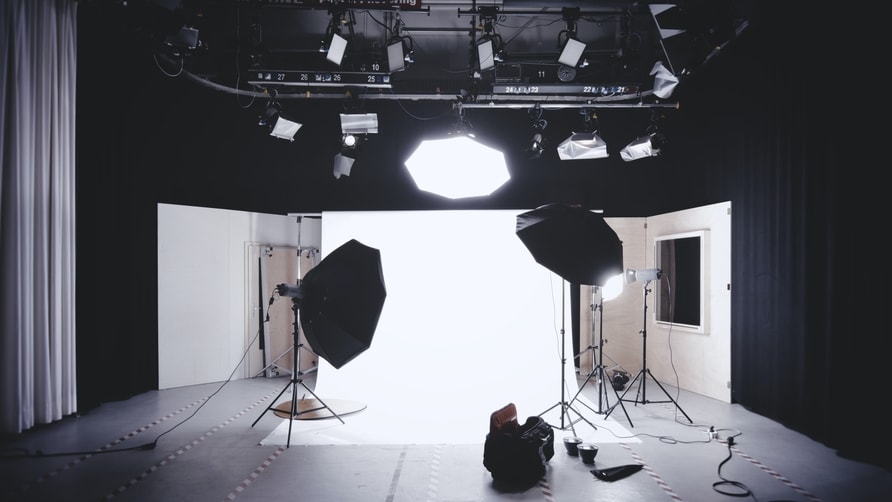 Photographers lights set up in an empty photography studio.