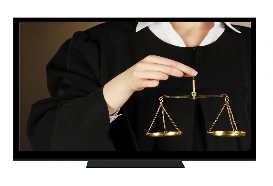 Judge in a video screen holding scales of justice in virtual court hearings