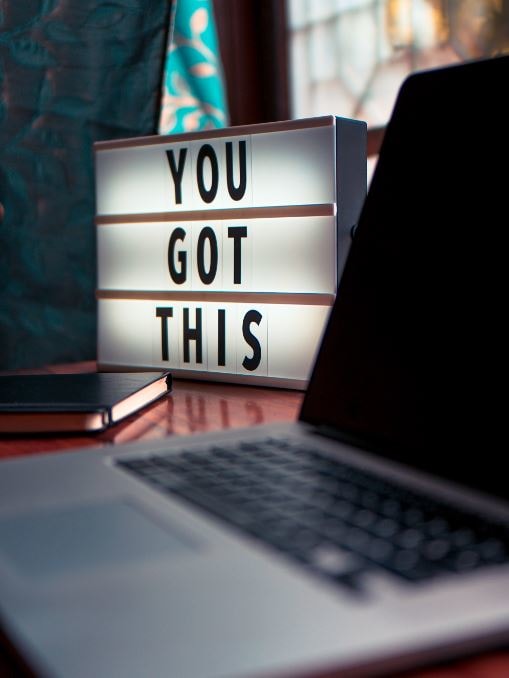 Lightbox with the words "You Got This" sitting next to an open laptop.