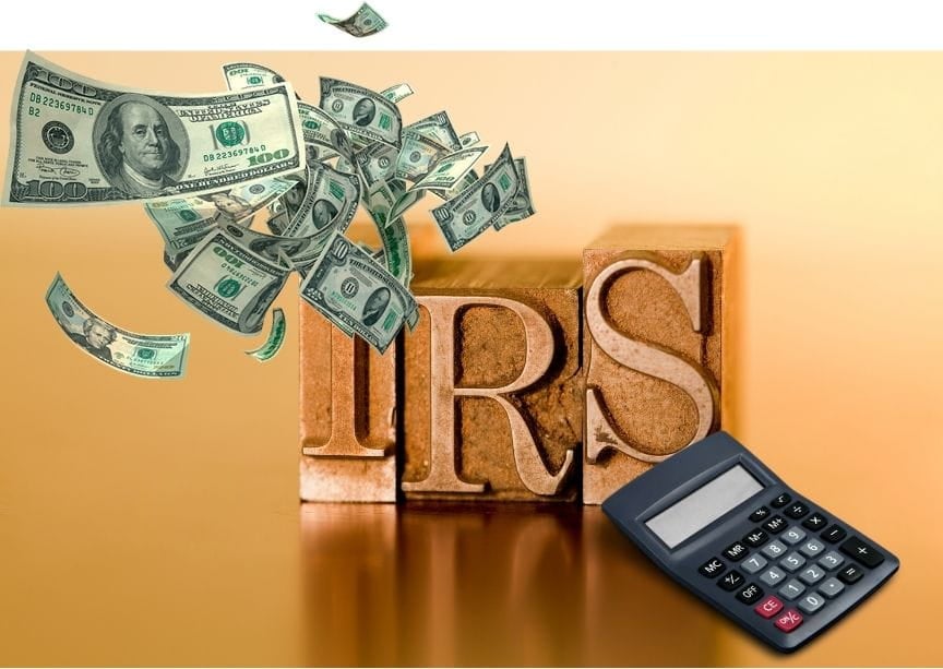 IRS in wooden blocks with cash and a calculator on the side. divorce and taxes