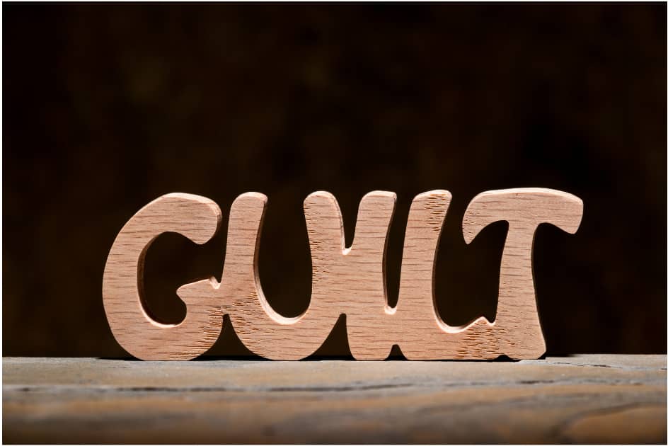 Word "Guilt" carved out ofwood