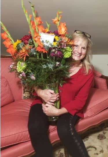Karen Covy with flowers from a satisfied client.