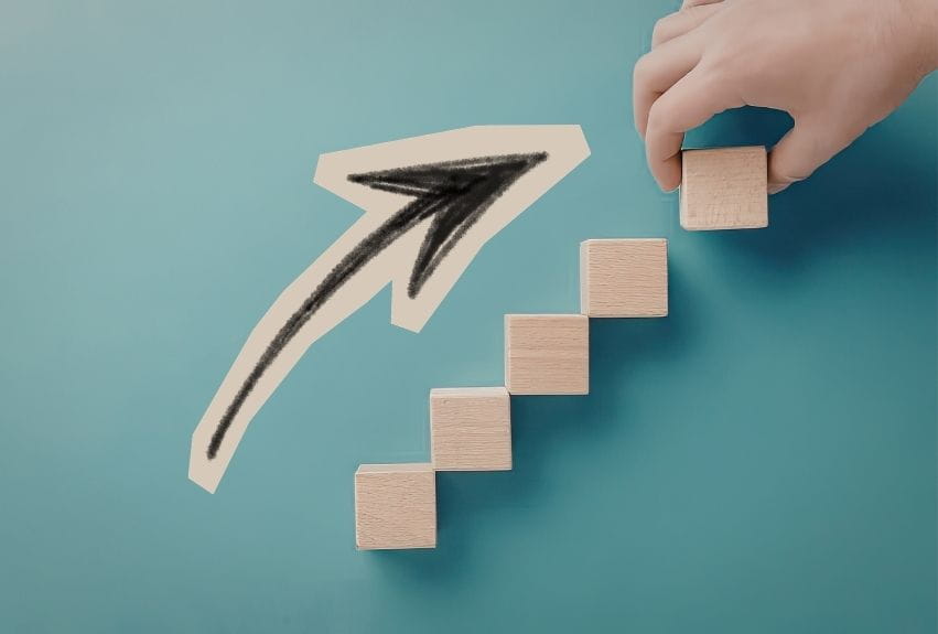using blocks as steps and an arrow pointing upwards