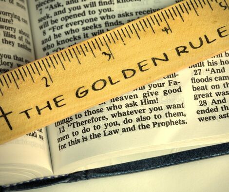 Open Bible with a golden ruler over it saying "The Golden Rule"