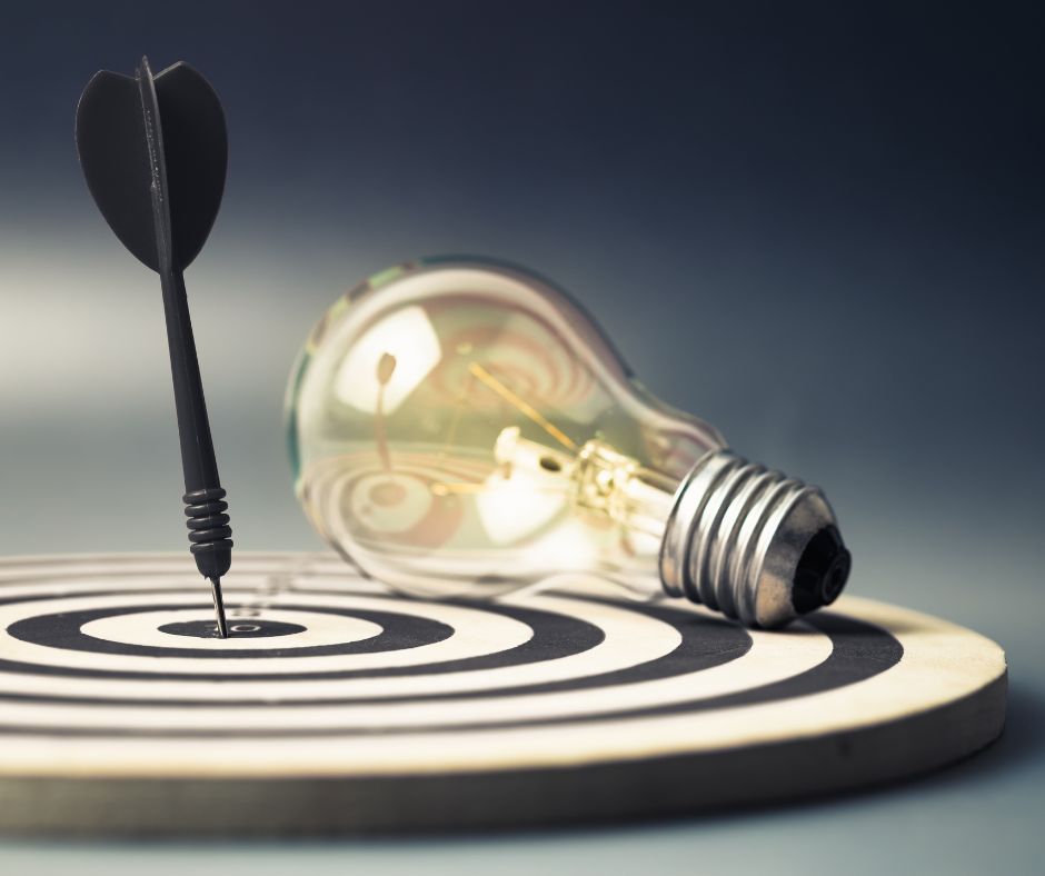 Lightbulb on a bulls-eye, signifying achieving your goal.