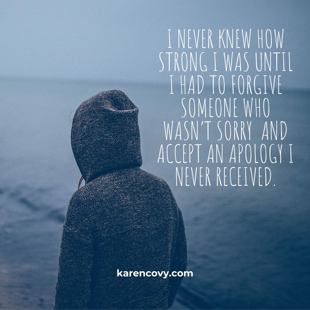 Back of a person in a hoodie walking by the ocean with the quote: i never knew how strong I was until i had to forgive someone who wasn’t sorry  and accept an apology I never received.
