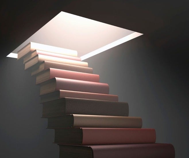 Stack of books leading like stairs from basement to a cutout hole on the main floor with the light shining through, symbolziing knowledge is power.