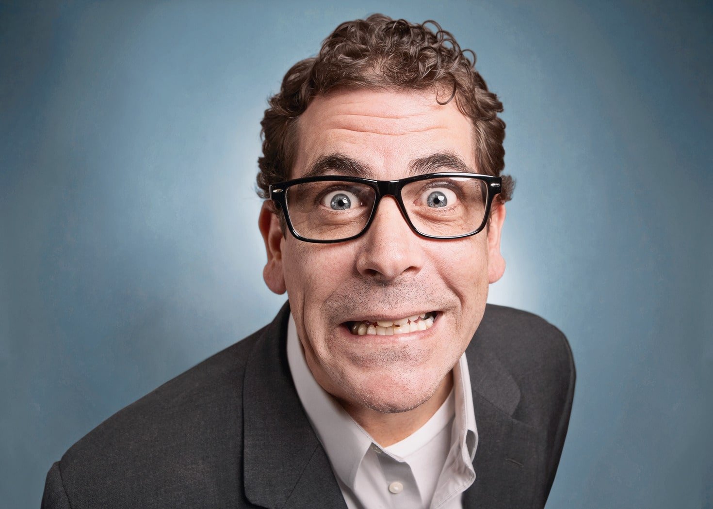 Geeky man who's a control freak looking anxious.
