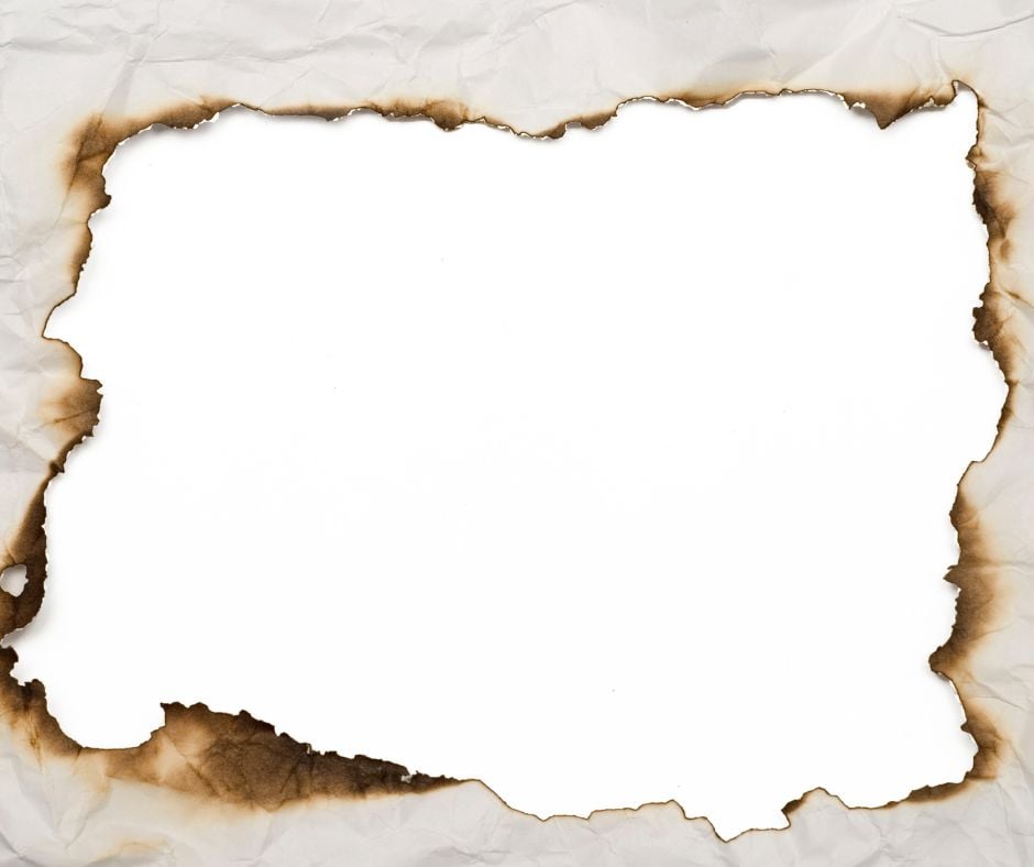 Reframe Piece of paper with a rectangle burned through the middle making a reframe of the way you see life.