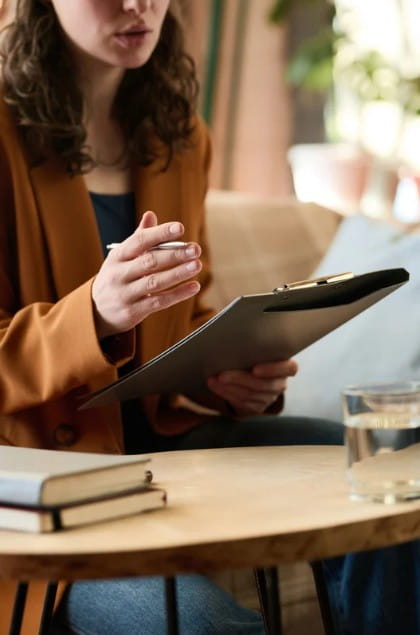 Talk to Your Therapist Young therapist with a clipboard talking with a divorce client.