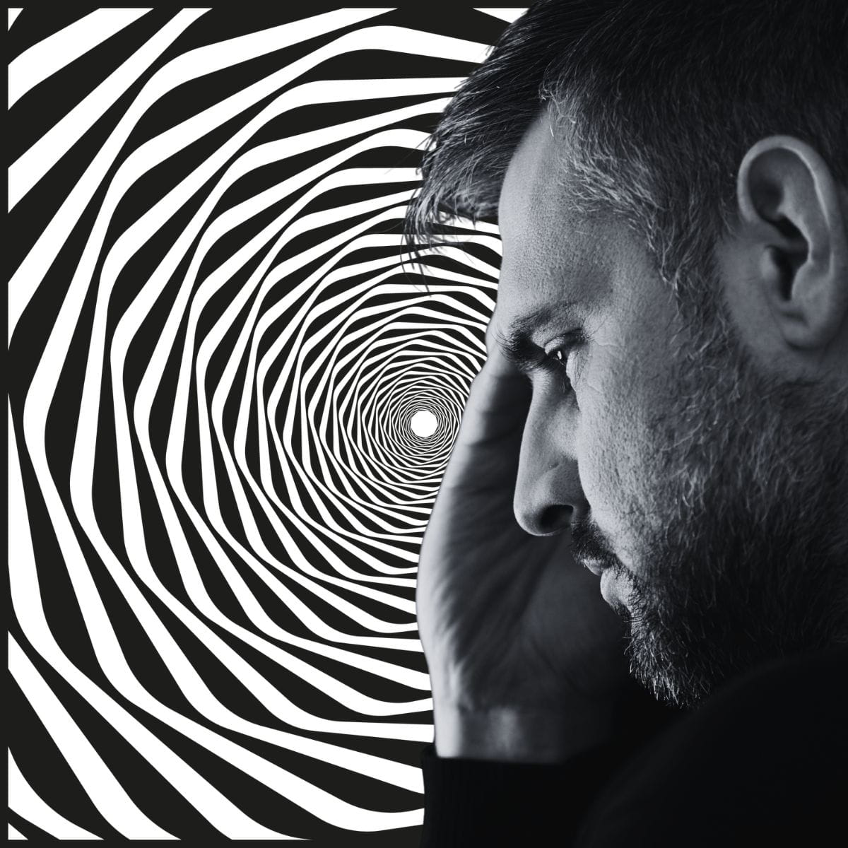 Emotional Spiralling Black and white image of a man in front of a spiral, signifying spirally emotions.