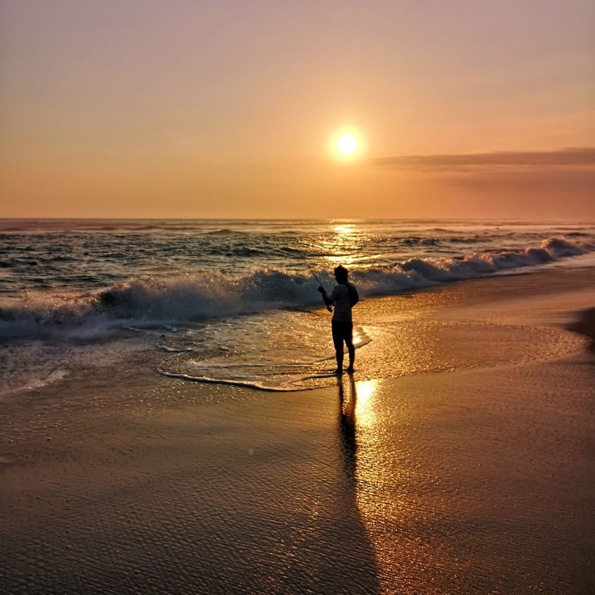 How to Let Go in a Divorce How to Let Go: Person with outstretched arms on a beach at sunrise.