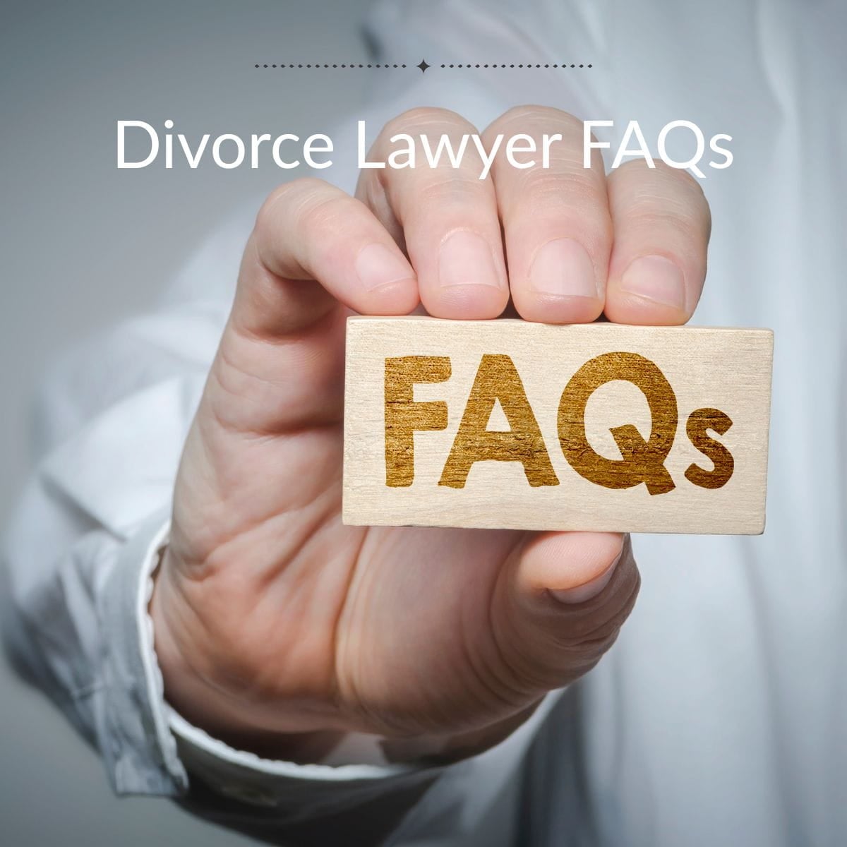 Divorce Lawyer FAQs Close up of a man's hand holding a sign that says "FAQs" under title Divorce lawyer FAQs.
