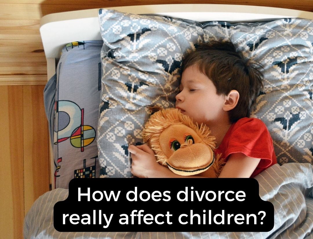 A kid sleeping with a stuffed monkey in bed.