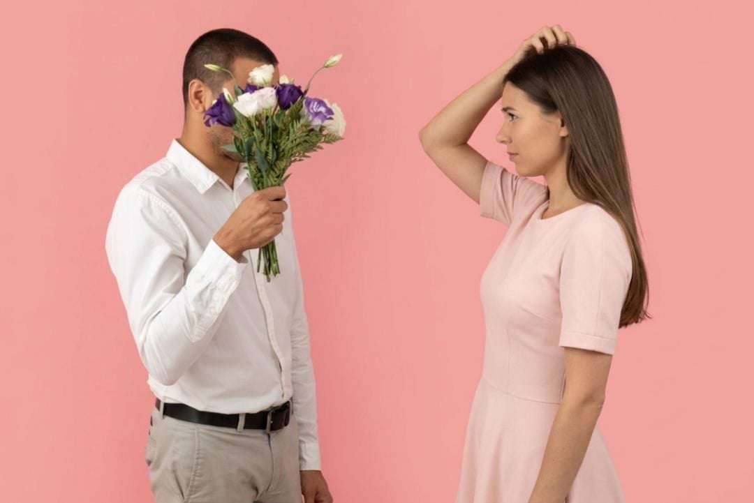 AI image of a man holding up a bouquet of flowers so they cover his face. The woman he is giving them too scratches her head