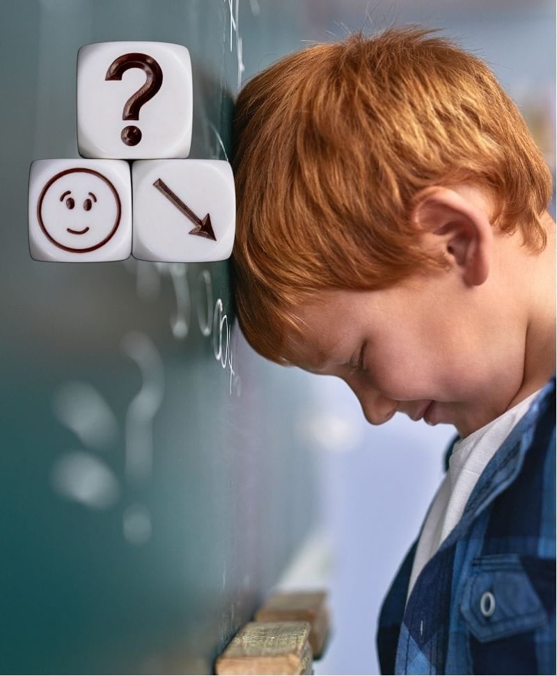 A child looking sad, leaning his head forward on the wall