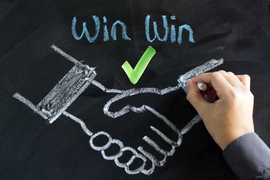 A chalkboard drawing of a handshake. The words "Win win" are written with a check underneath