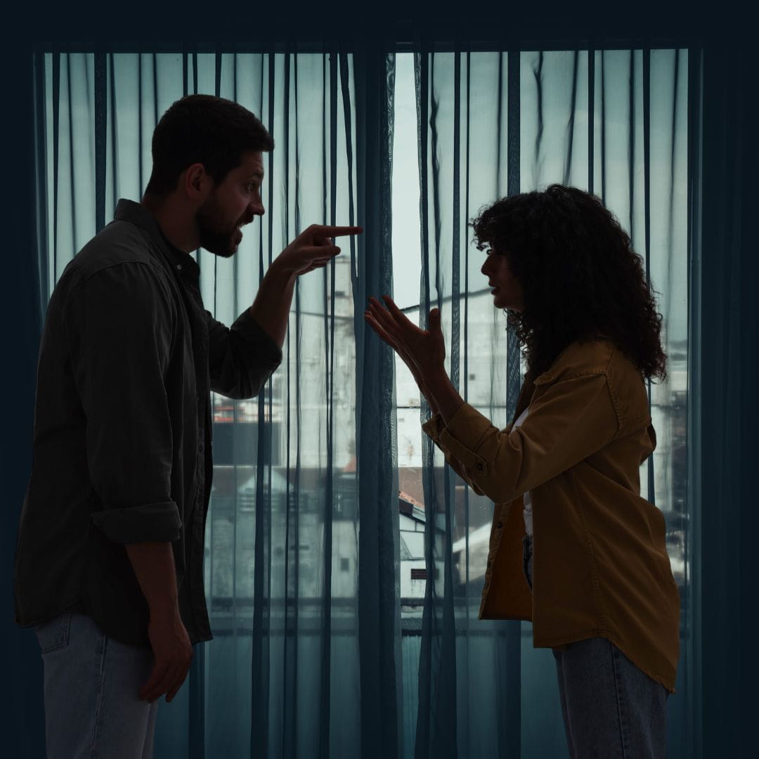 Arguing with your spouse Silhoutte of a couple arguing in front of a curtained window.