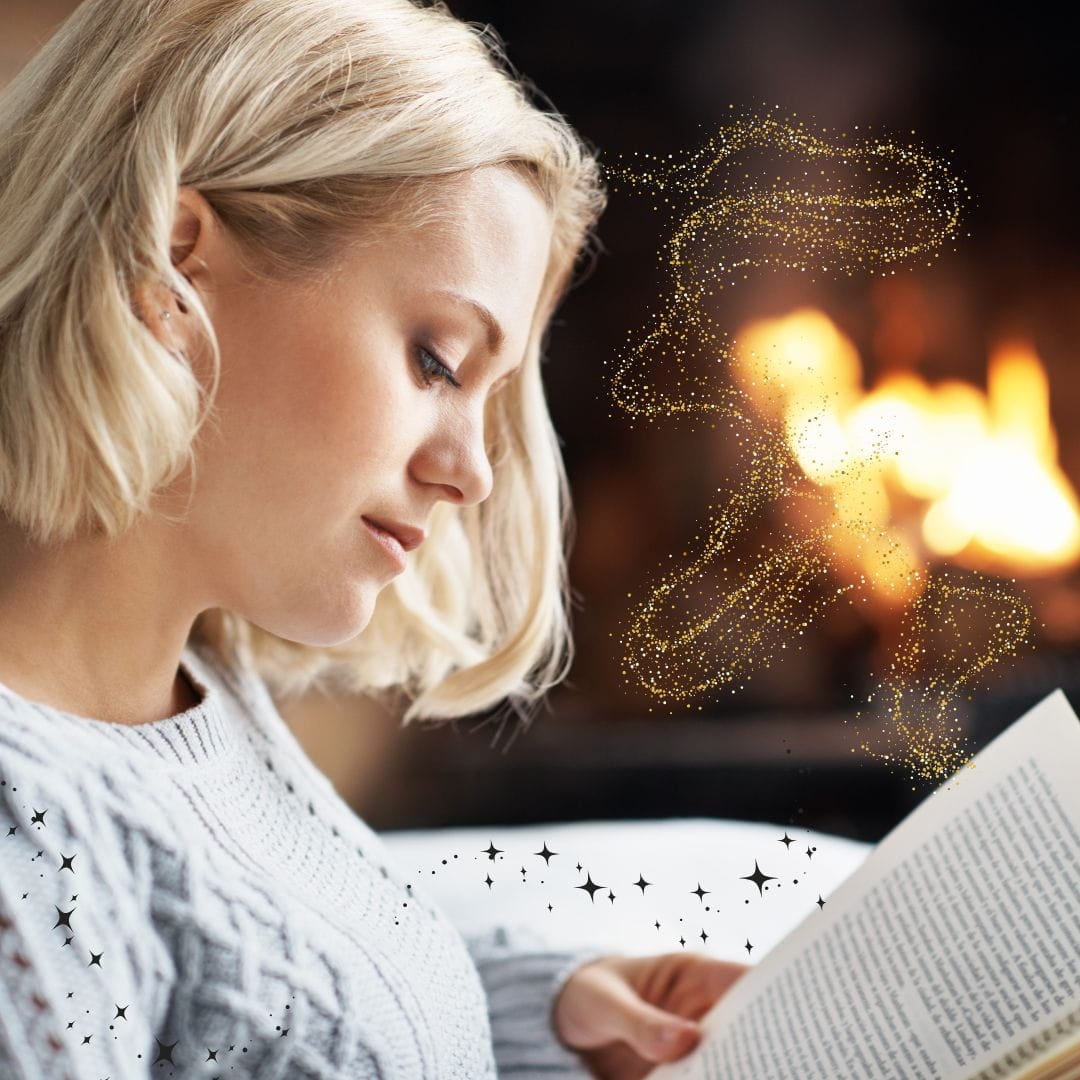 Woman reading a divorce book in front of a fire with fairy dust coming from the book to her head.