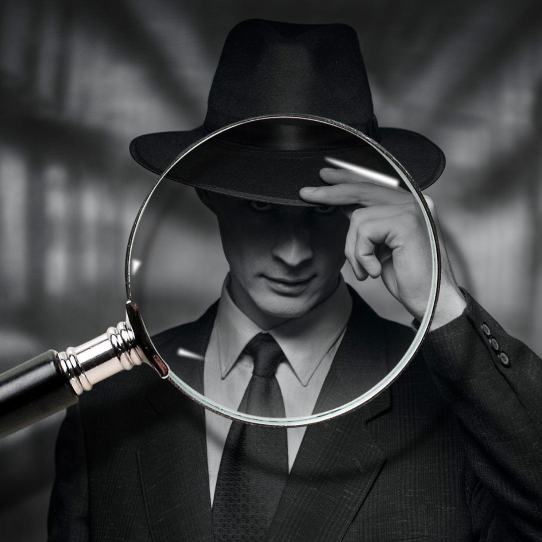 Keep it Confidential Black and white image of a 1940s man in a file room tipping his hat with a magnifying glass over him signifying keep it confidential.