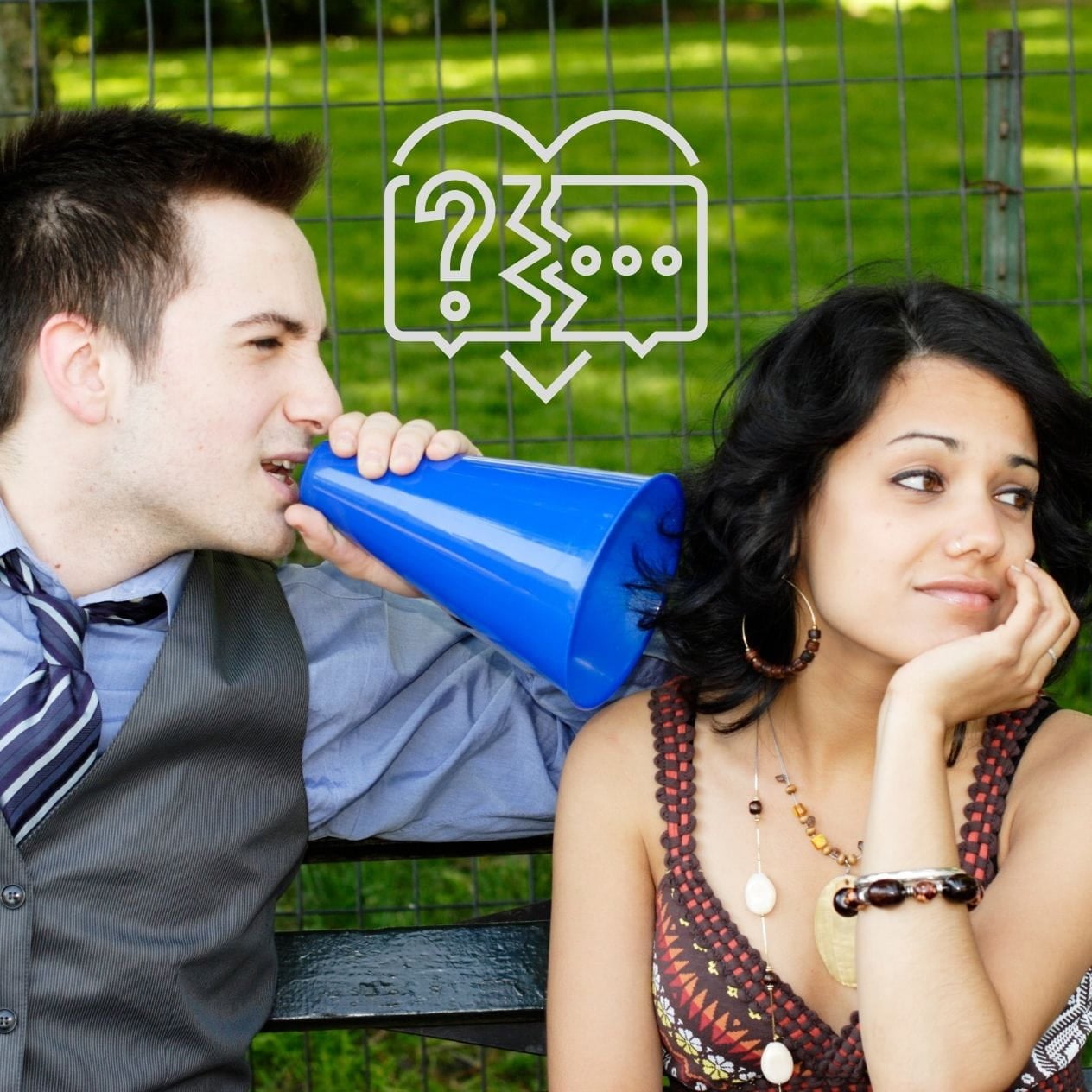 Lack of Communication Man with a megaphone talking in the ear of a woman who's not listening.