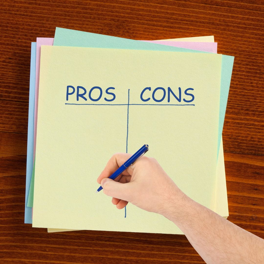 Pros and COns list with a hand writing on it.