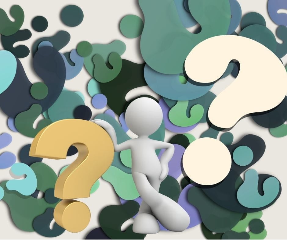 Claymation figure in front of mutli-colored cut out question marks.