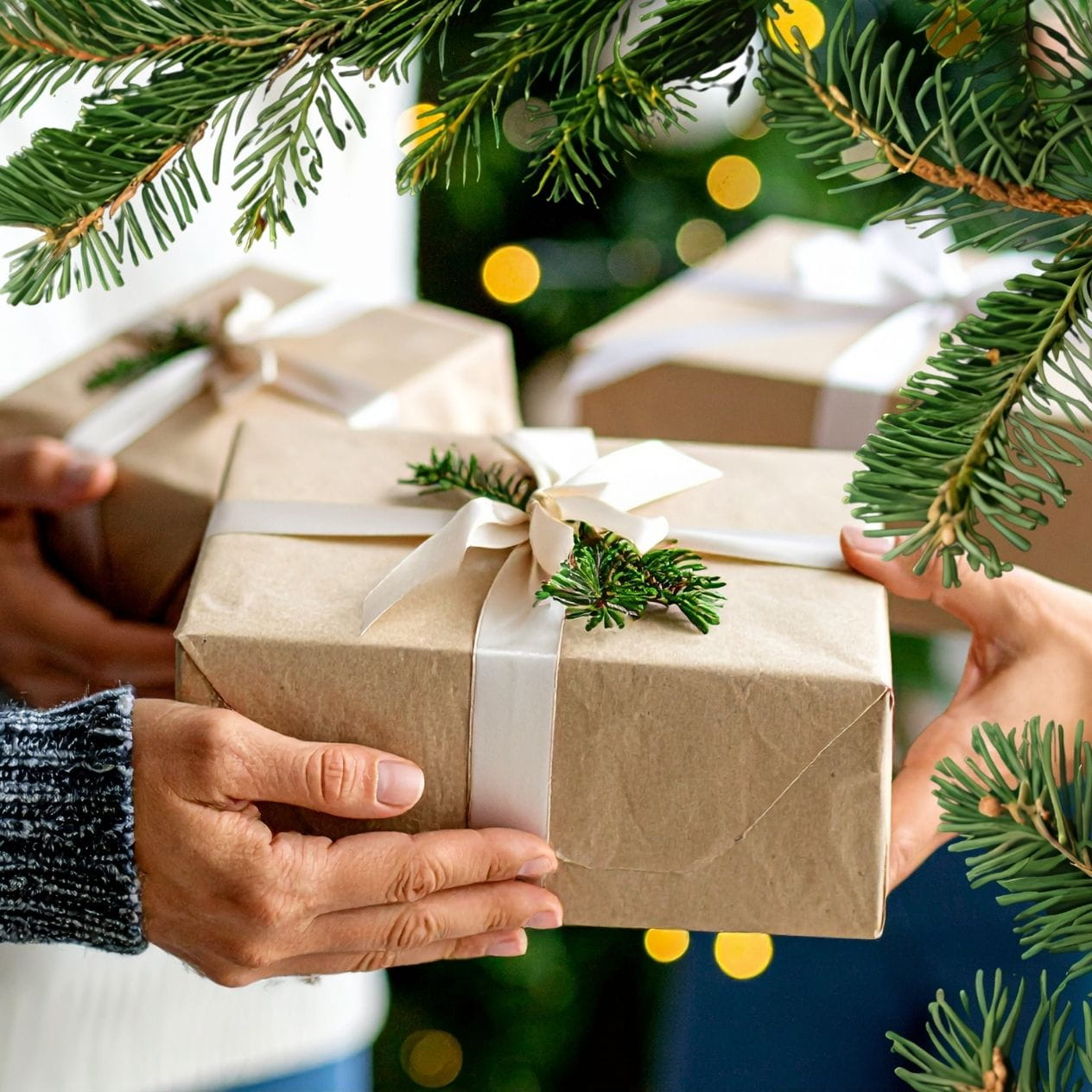 One person giving a gift to another at Christmas.